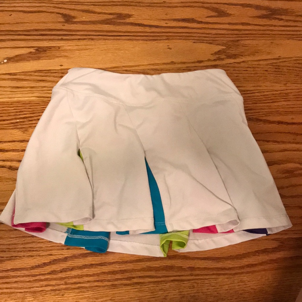 White Fila tennis skirt w/ colorful cutout shapes